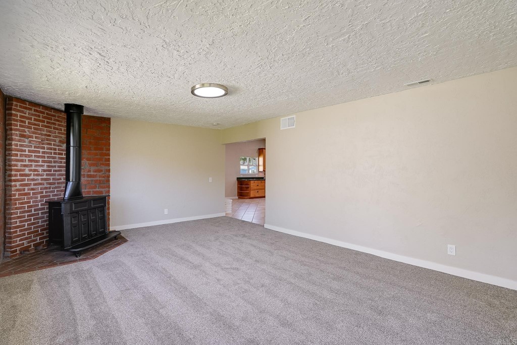 225 Hypoint Place Escondido, CA 92027 - Photo 20 of 63 a view of an empty room with wooden floor and a window