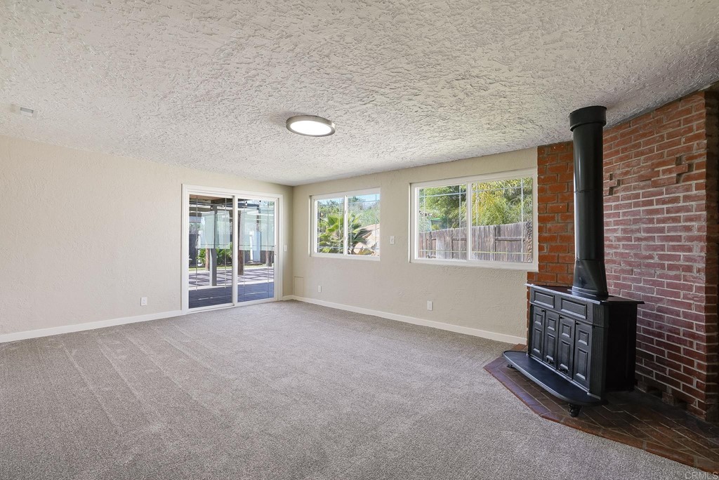 225 Hypoint Place Escondido, CA 92027 - Photo 3 of 63 a view of an empty room with a fireplace and a window