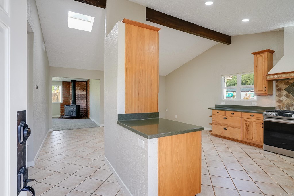225 Hypoint Place Escondido, CA 92027 - Photo 10 of 63 a kitchen with granite countertop a stove a sink and a refrigerator