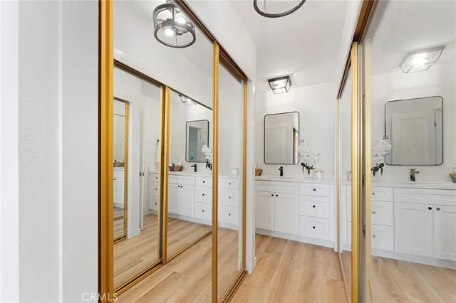 a bathroom with a granite countertop tub shower vanity and mirror