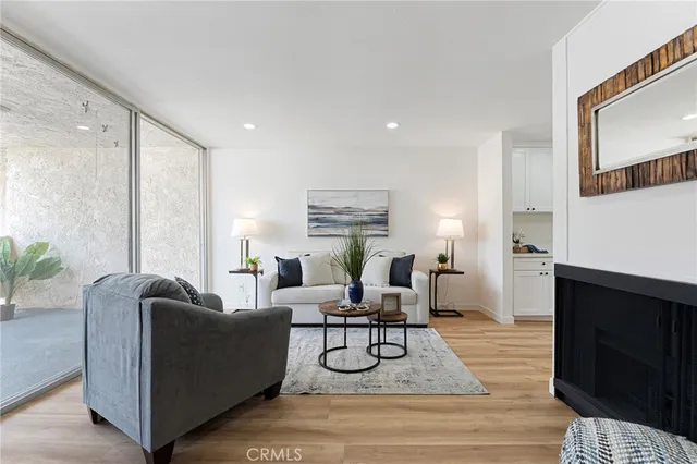 a living room with furniture fireplace and rug