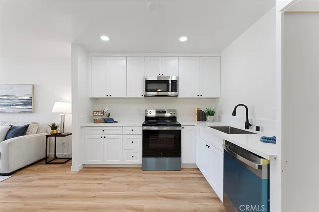 a kitchen with a sink and a stove top oven