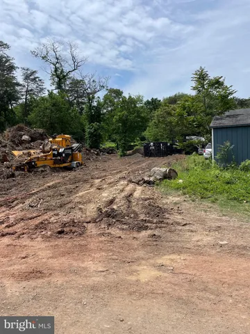 a view of a yard with a car parked