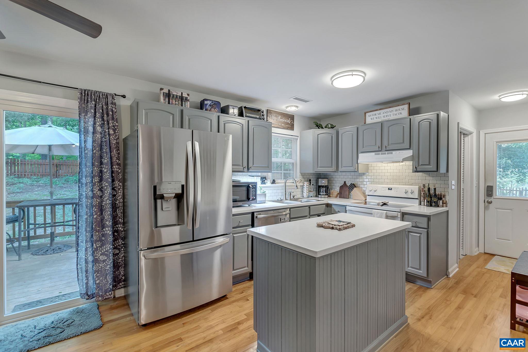 92 Riverside Drive Palmyra, VA 22963 - Photo 14 of 48 a kitchen with a refrigerator a sink and a stove top oven
