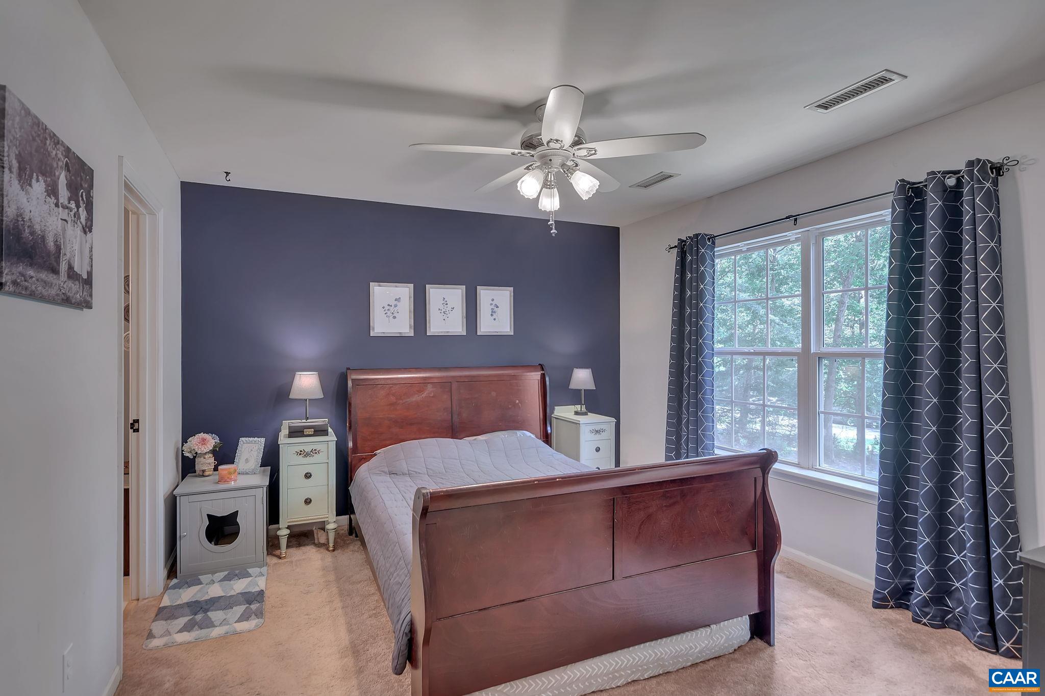 92 Riverside Drive Palmyra, VA 22963 - Photo 21 of 48 a bed room with a bed and a chandelier