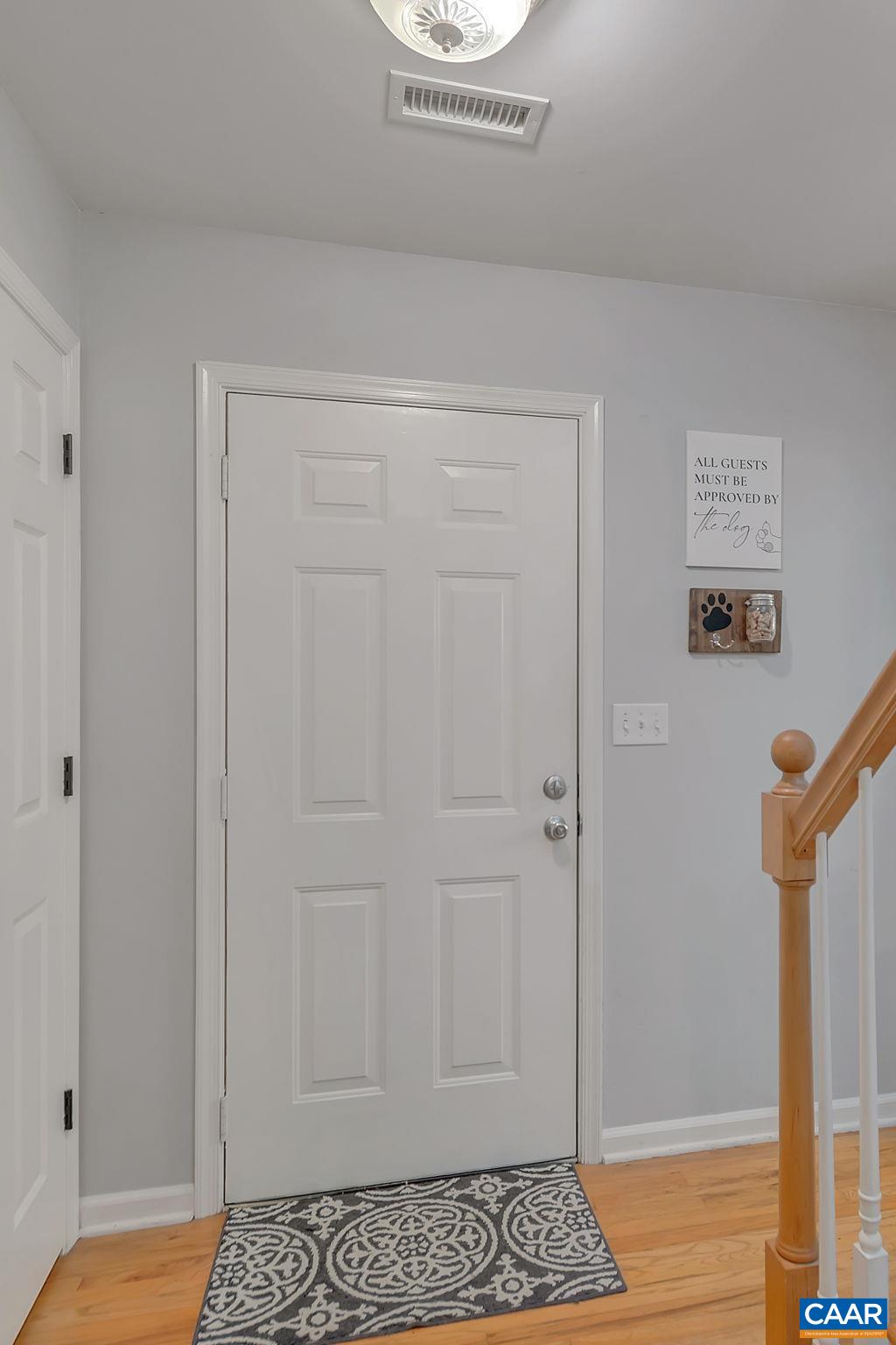 92 Riverside Drive Palmyra, VA 22963 - Photo 4 of 48 a view of a hallway with wooden floor and a potted plant