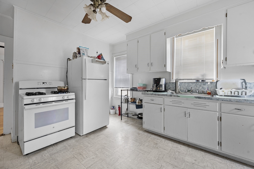 89 Central Street Somerville, MA 02143 - Photo 12 of 33 a kitchen with cabinets and white appliances