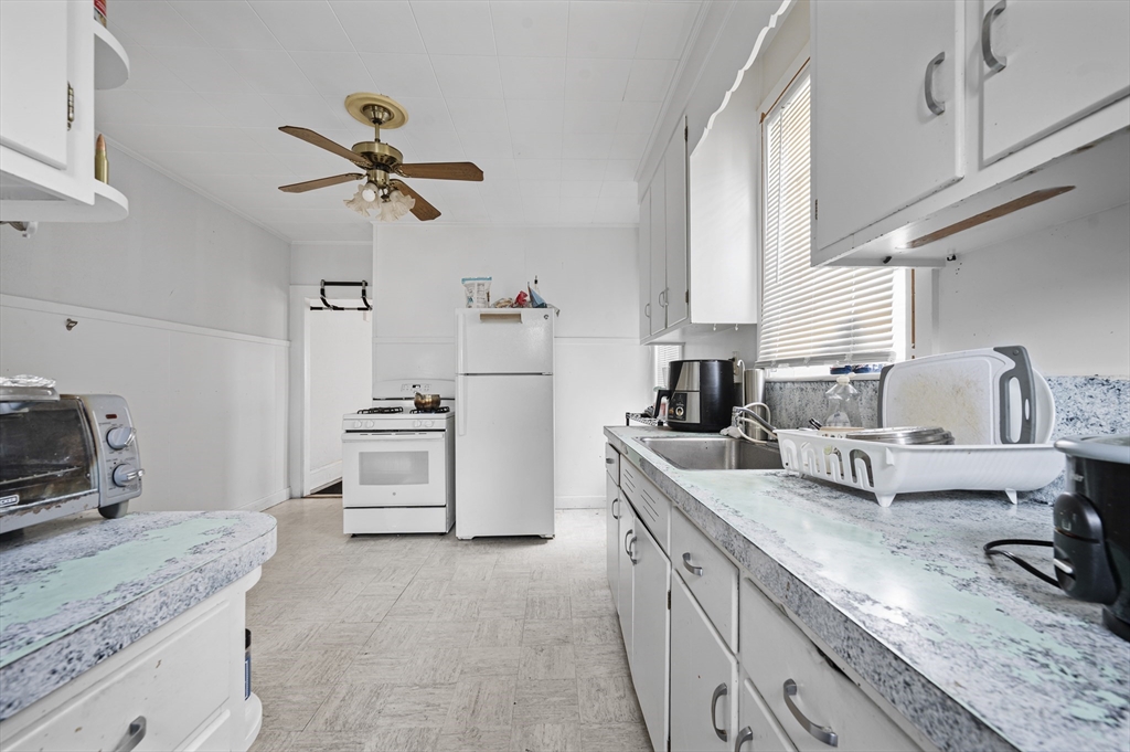 89 Central Street Somerville, MA 02143 - Photo 13 of 33 a kitchen with white cabinets and appliances
