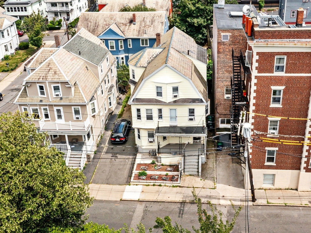 89 Central Street Somerville, MA 02143 - Photo 30 of 33 a view of a building with a yard