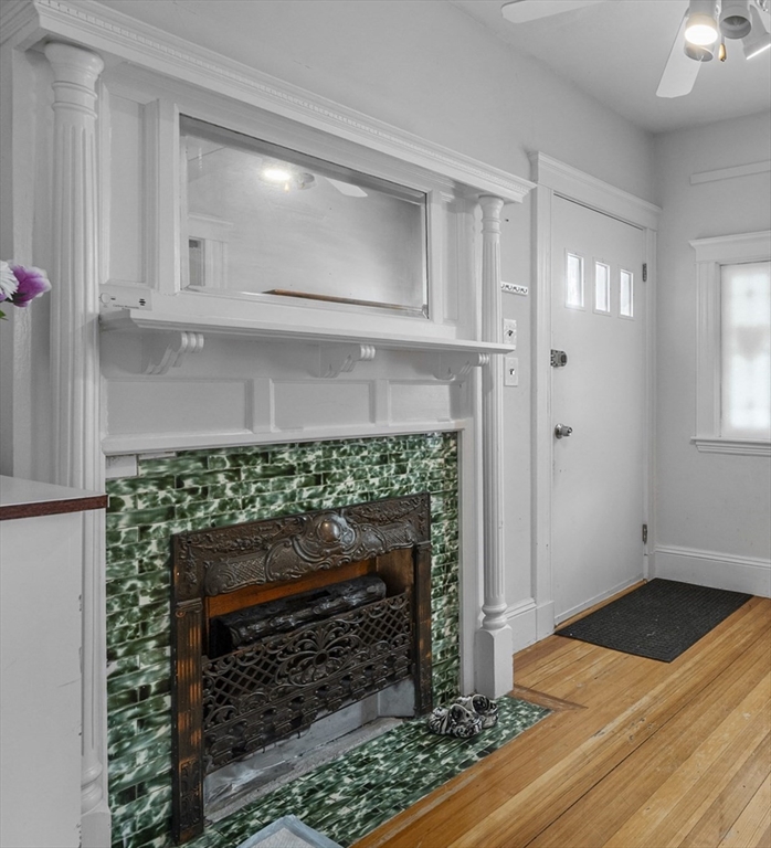 89 Central Street Somerville, MA 02143 - Photo 6 of 33 a room with fireplace and wooden floor