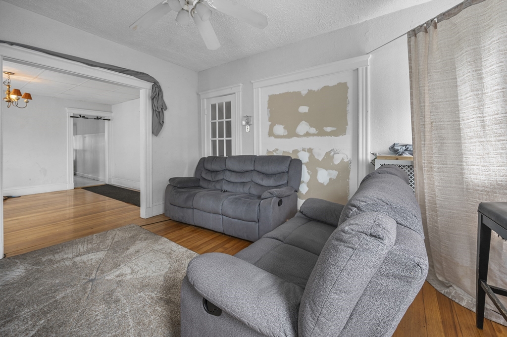 89 Central Street Somerville, MA 02143 - Photo 9 of 33 a living room with furniture and a large window