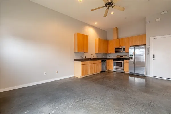 a kitchen with cabinets and stainless steel appliances