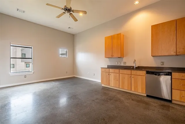 a kitchen with cabinets and stainless steel appliances
