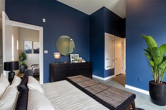 a bedroom with a bed and a potted plant