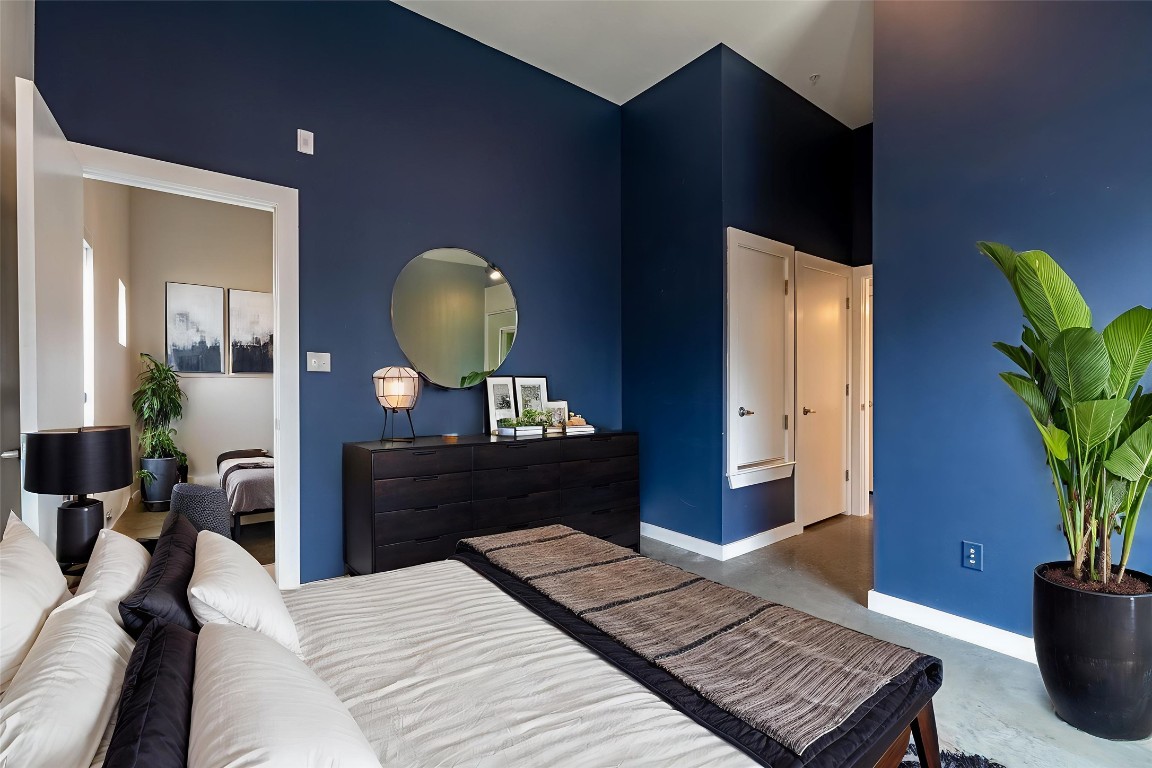 6000 South Congress Avenue, Unit 128 Austin, TX 78745 - Photo 6 of 15 a bedroom with a bed and a potted plant