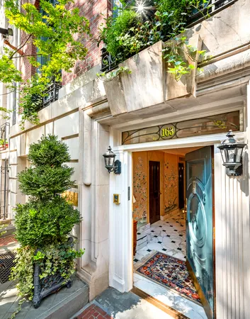 a view of a front door of the house and tree
