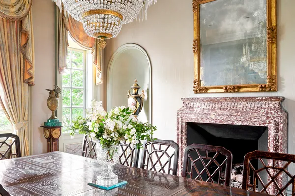 a living room with furniture a chandelier and a flat screen tv
