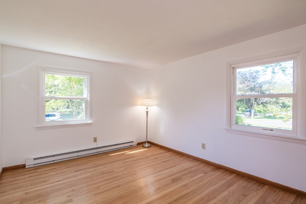 40 Farmington Road Amherst, MA 01002 - Photo 19 of 26 an empty room with wooden floor and windows