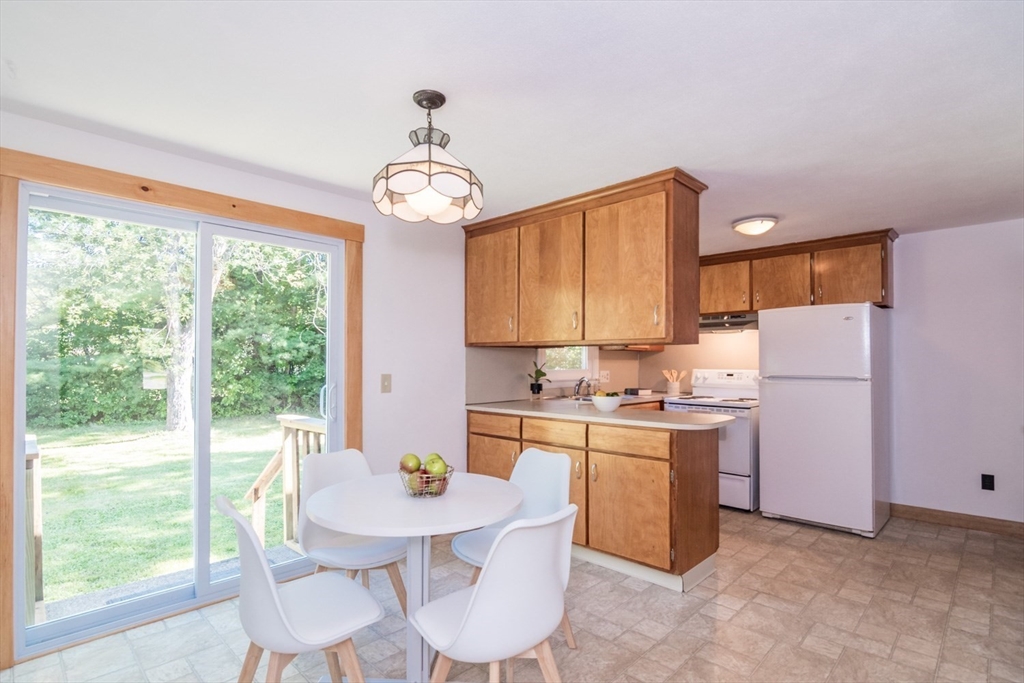 40 Farmington Road Amherst, MA 01002 - Photo 10 of 26 a kitchen with a dining table chairs and refrigerator