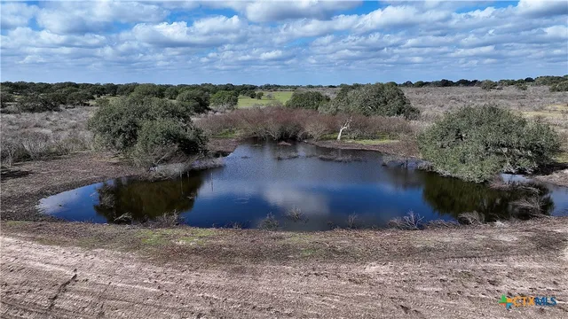 a view of a lake and green valley