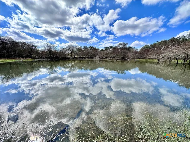 a view of a lake with houses in the back