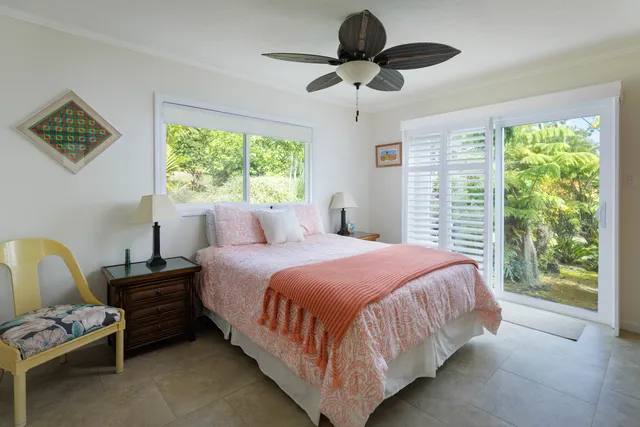 a bedroom with a bed chandelier and a window
