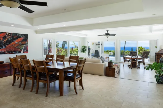 a view of a dining room and livingroom with furniture and kitchen view