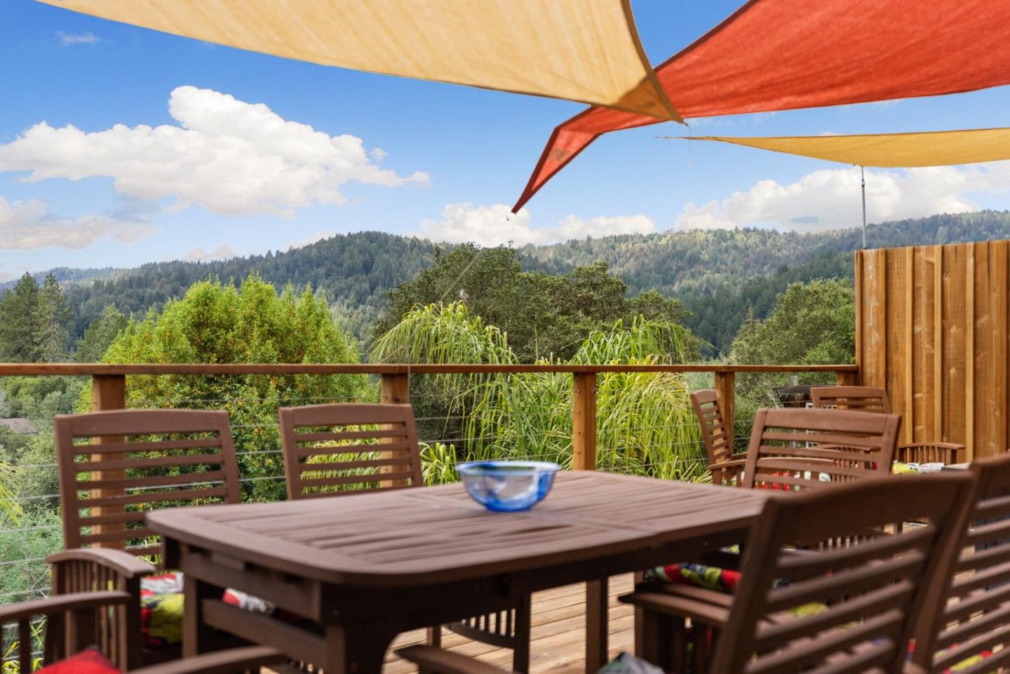 a view of a balcony with table and chairs and wooden floor