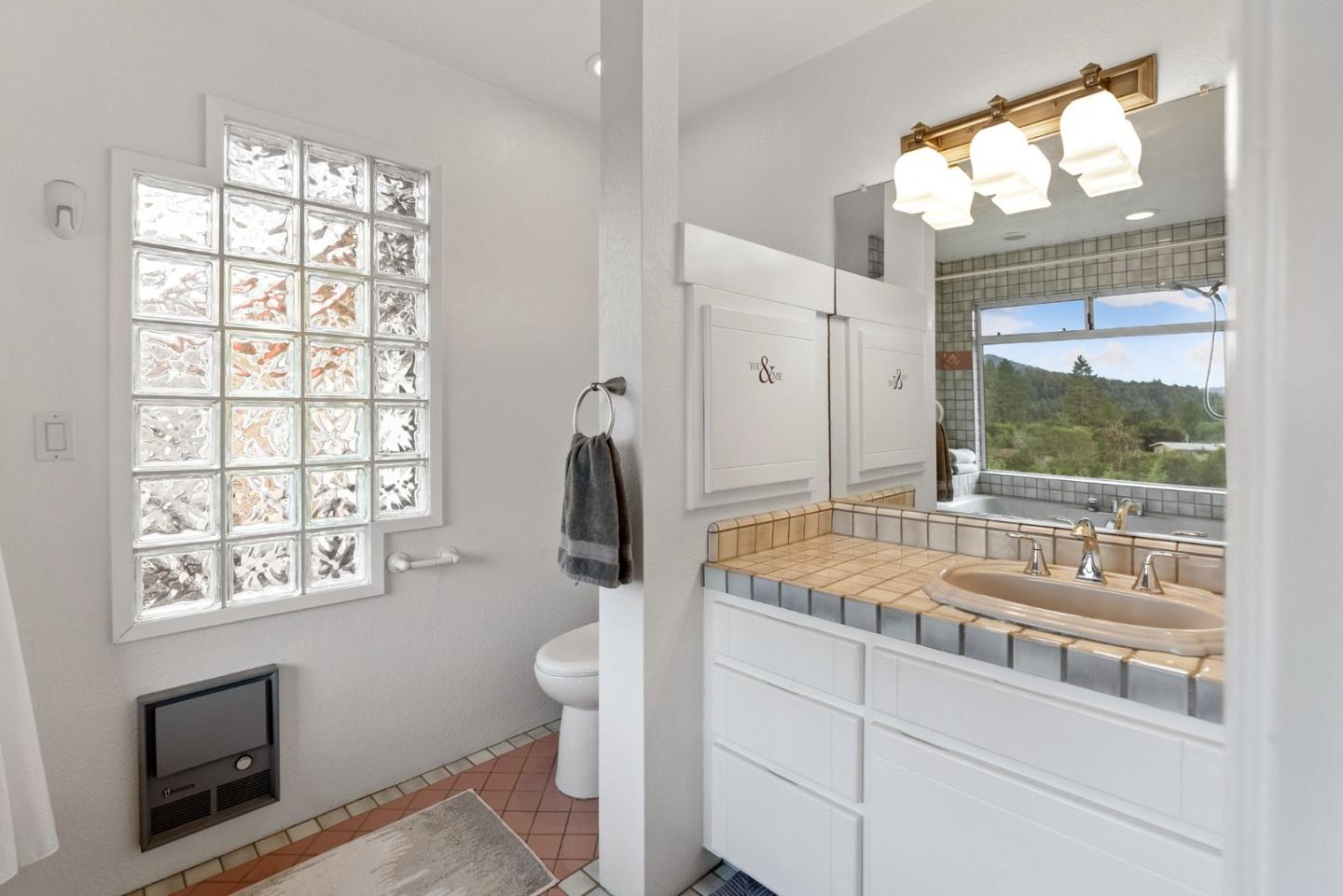 270 Estates Drive Ben Lomond, CA 95005 - Photo 44 of 61 a bathroom with a granite countertop sink and a large mirror