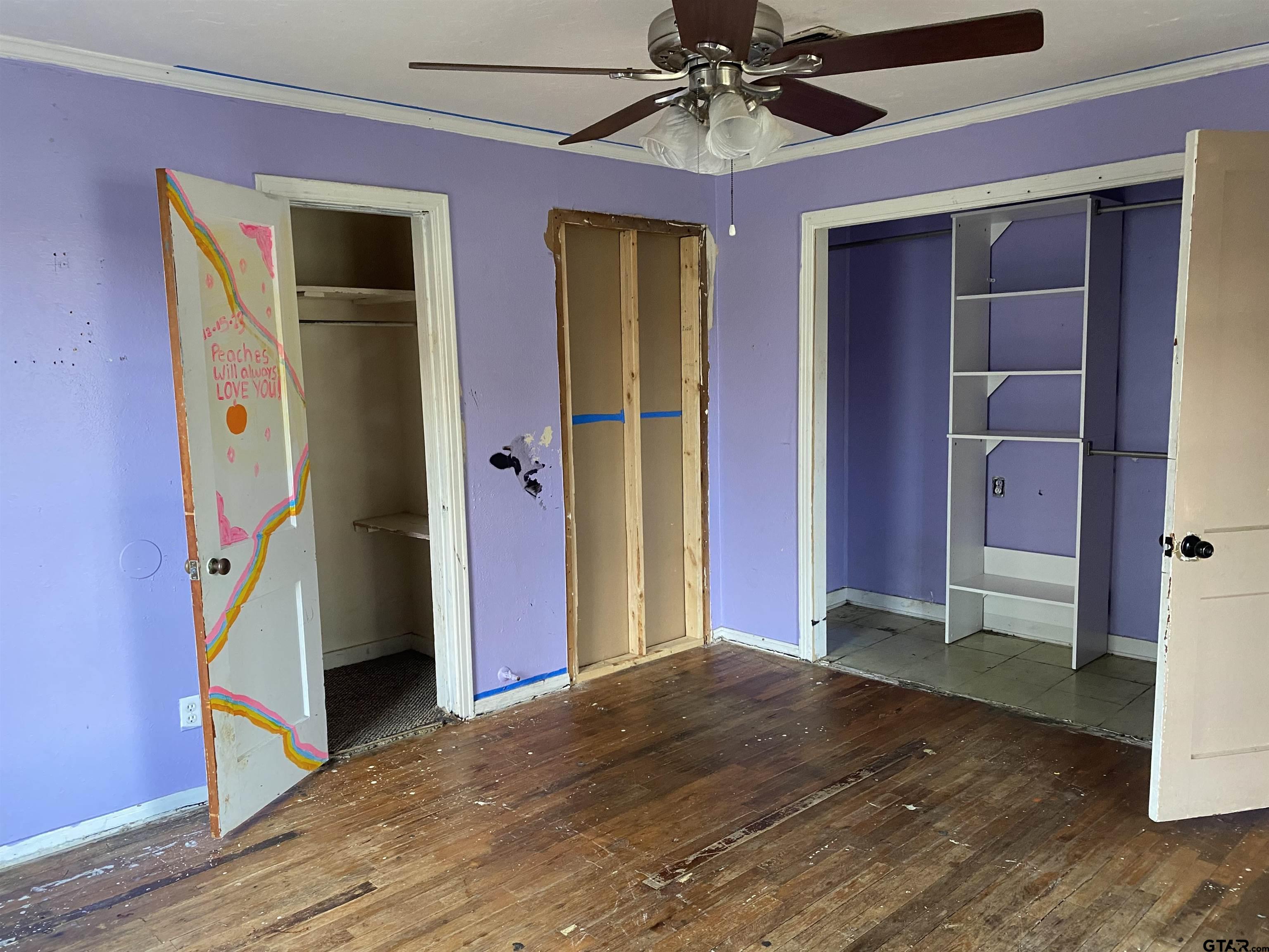 210 North Stephens Street Quitman, TX 75783 - Photo 11 of 28 a view of a hallway with wooden floor and closet