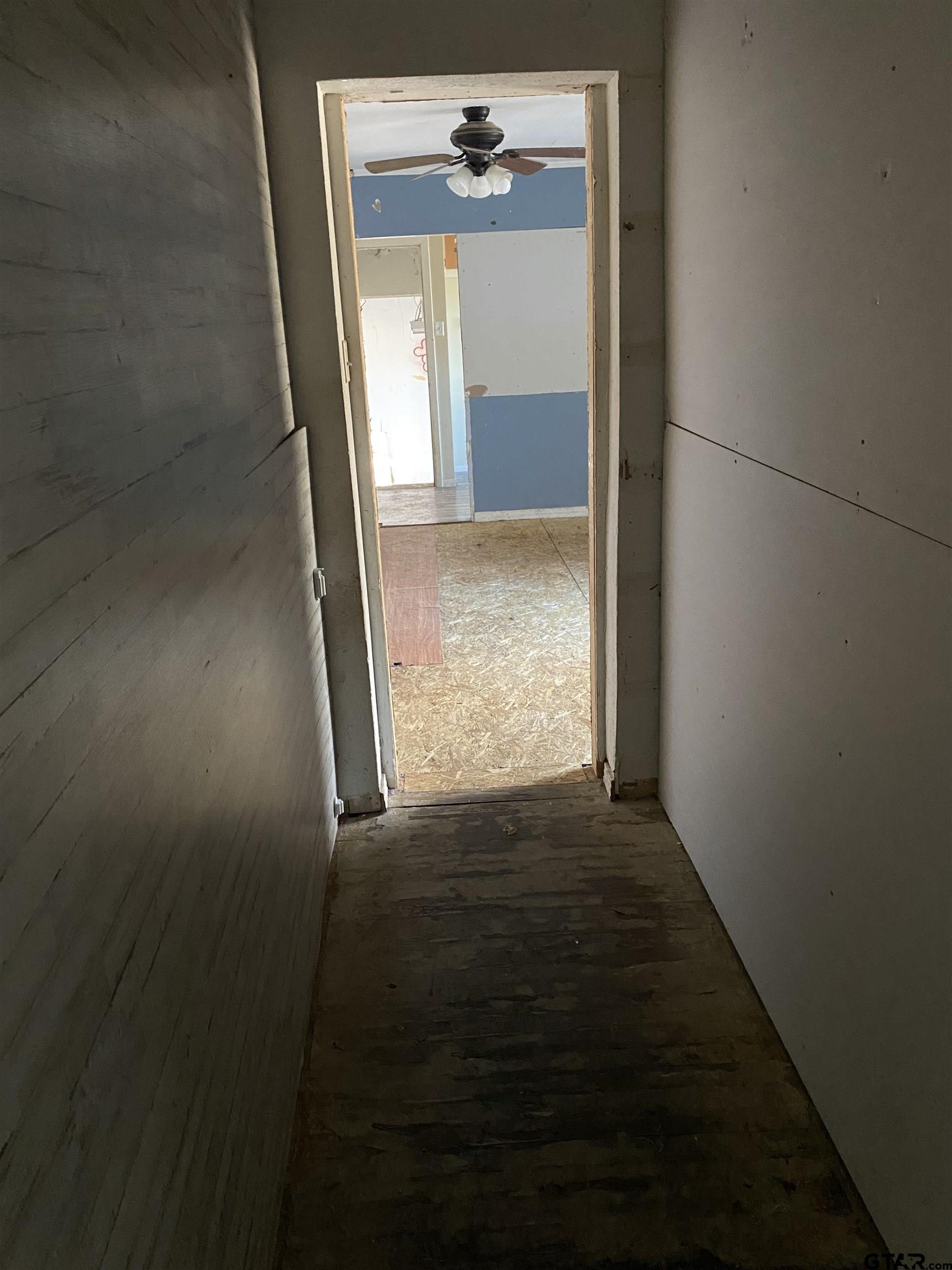 210 North Stephens Street Quitman, TX 75783 - Photo 14 of 28 wooden floor in an empty room with a window