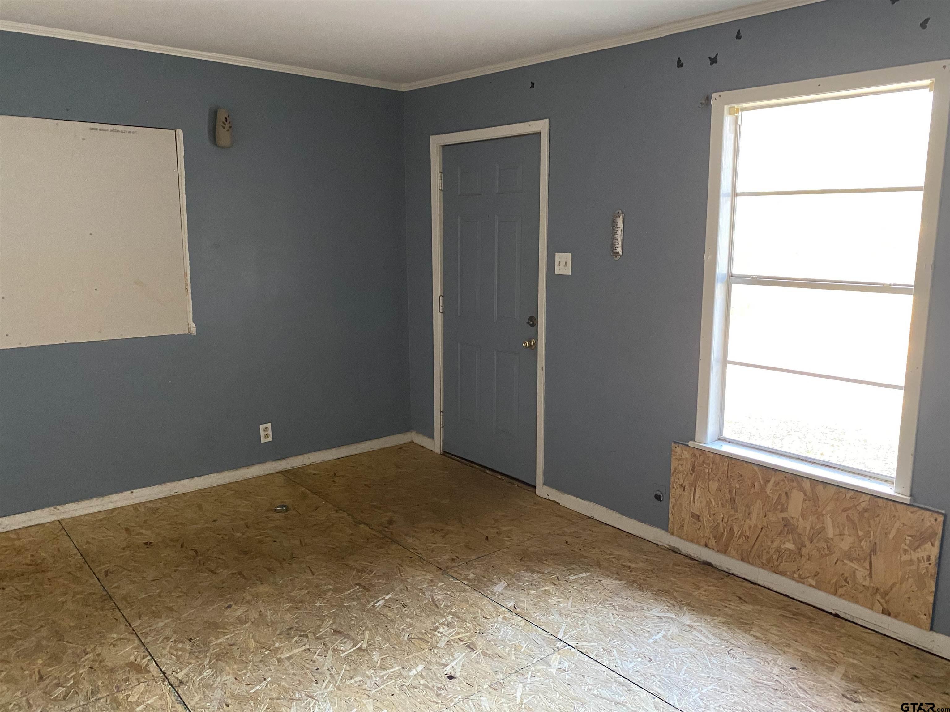 210 North Stephens Street Quitman, TX 75783 - Photo 15 of 28 a view of an empty room with a window