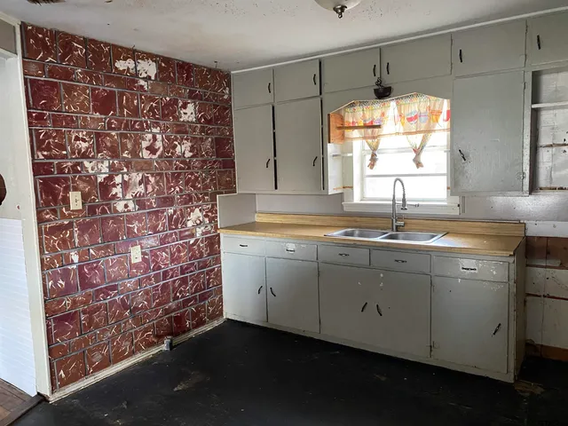 a kitchen with a sink and a window