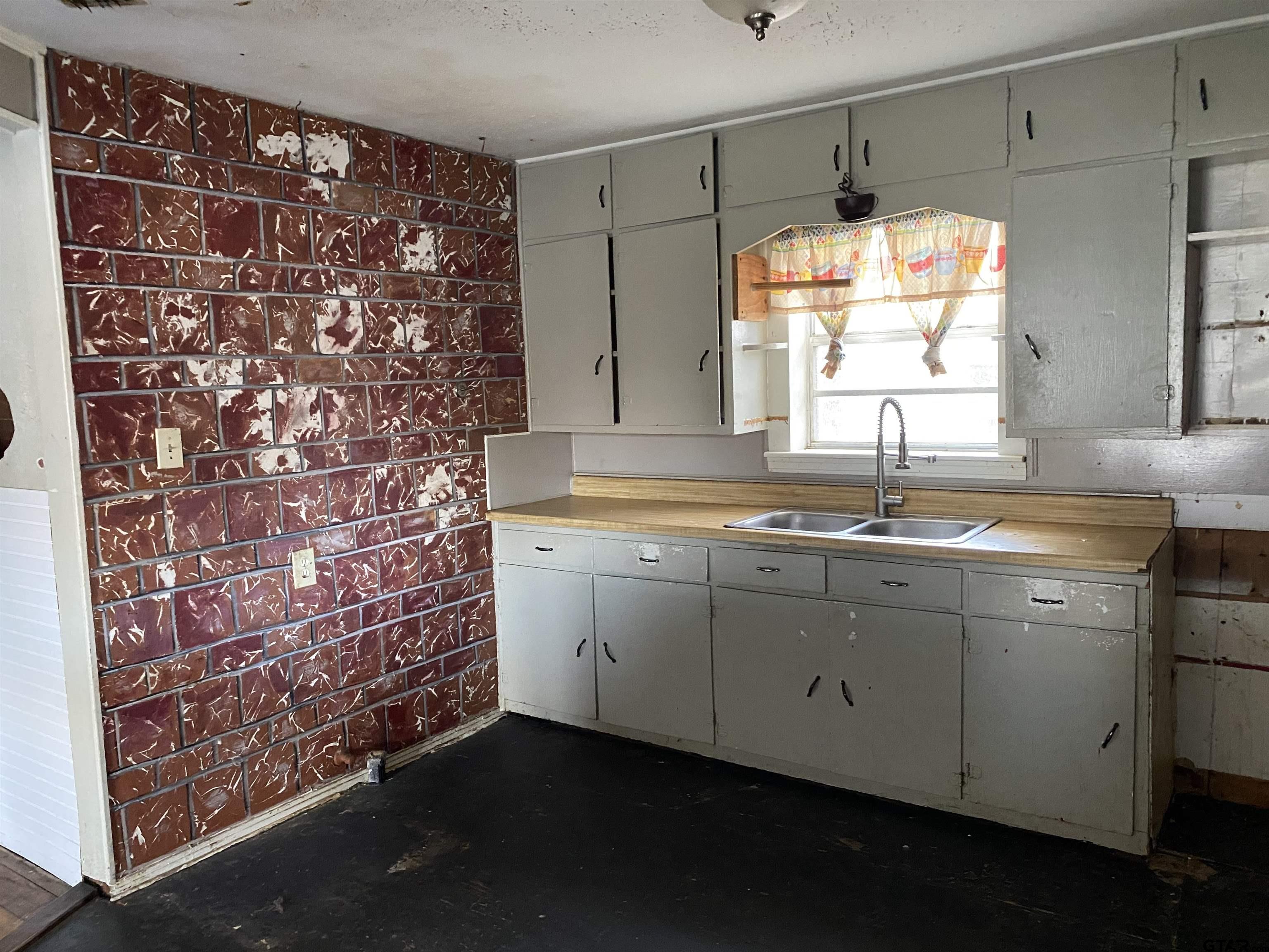 210 North Stephens Street Quitman, TX 75783 - Photo 4 of 28 a kitchen with a sink and a window