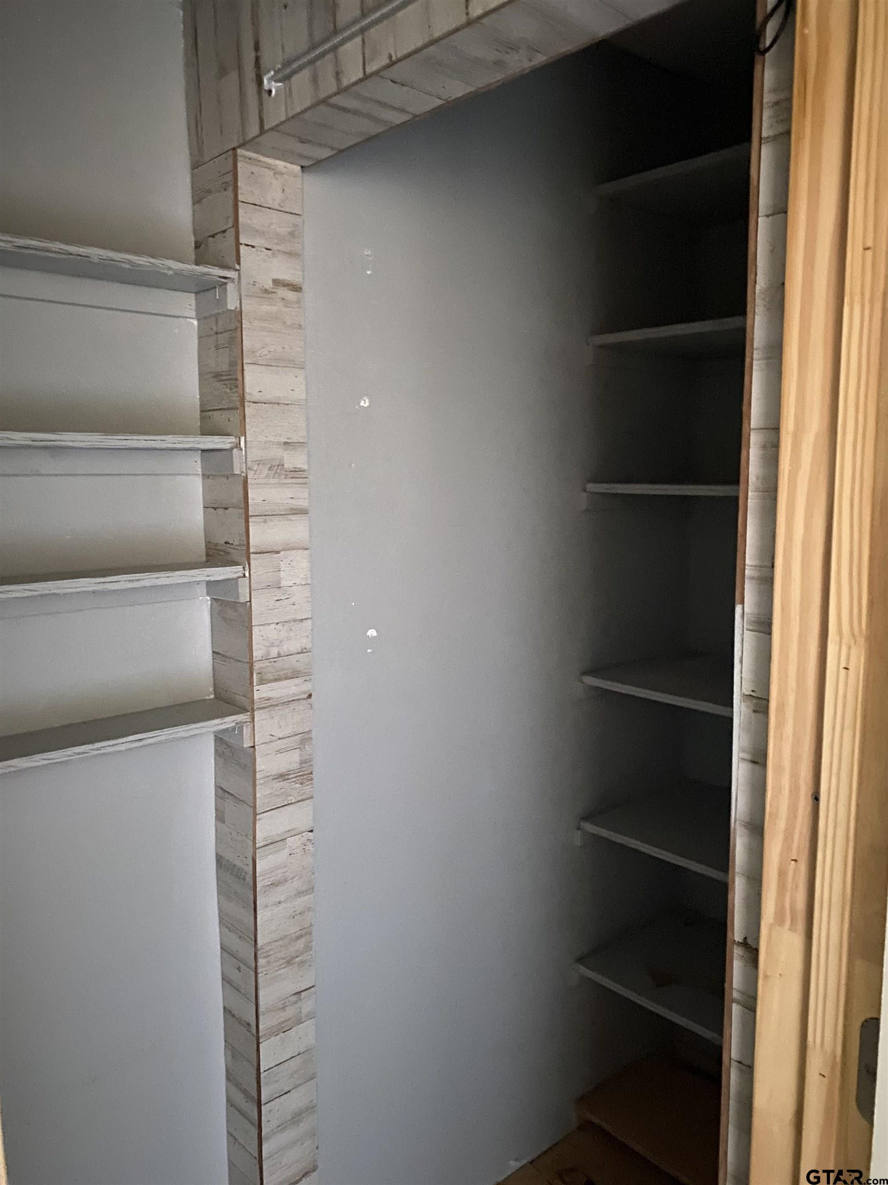 210 North Stephens Street Quitman, TX 75783 - Photo 7 of 28 a view of walk in closet with empty racks