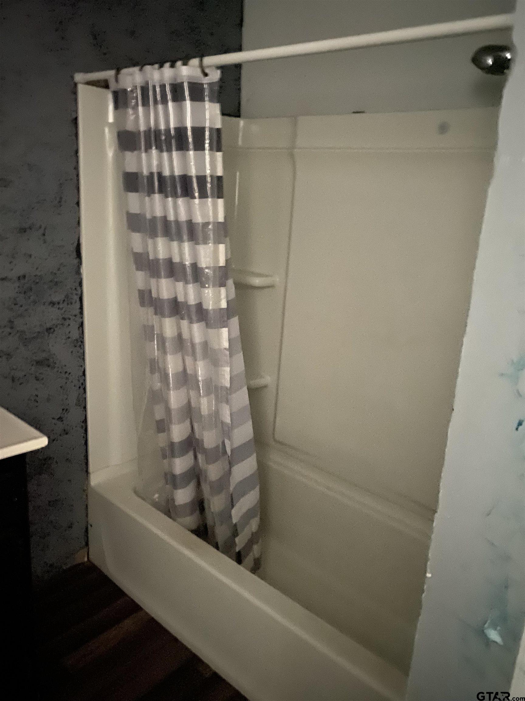 210 North Stephens Street Quitman, TX 75783 - Photo 9 of 28 a bathroom with a bathtub and shower