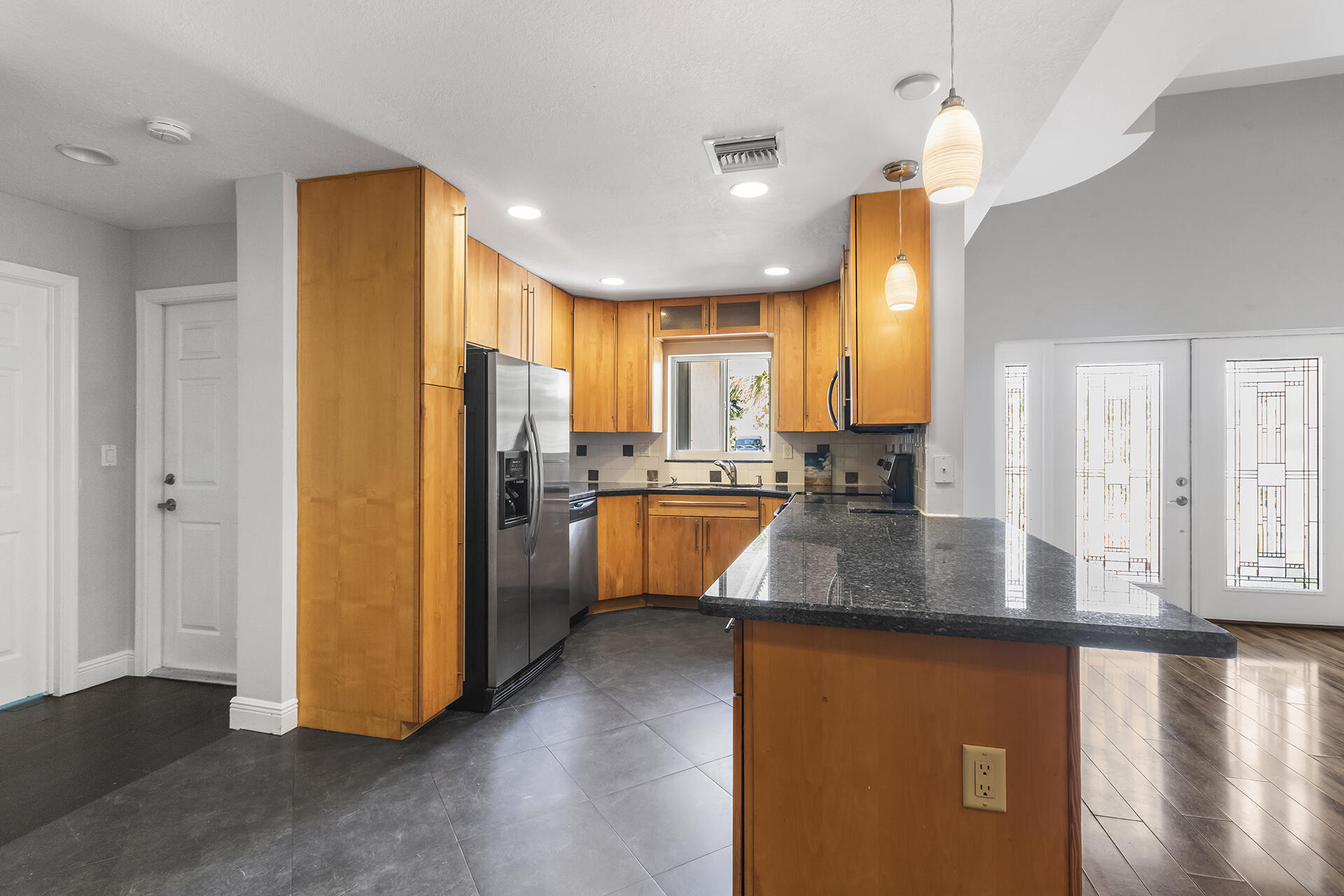 298 Northwest 11th Street Boca Raton, FL 33432 - Photo 11 of 21 a kitchen with stainless steel appliances granite countertop a refrigerator a sink and a stove