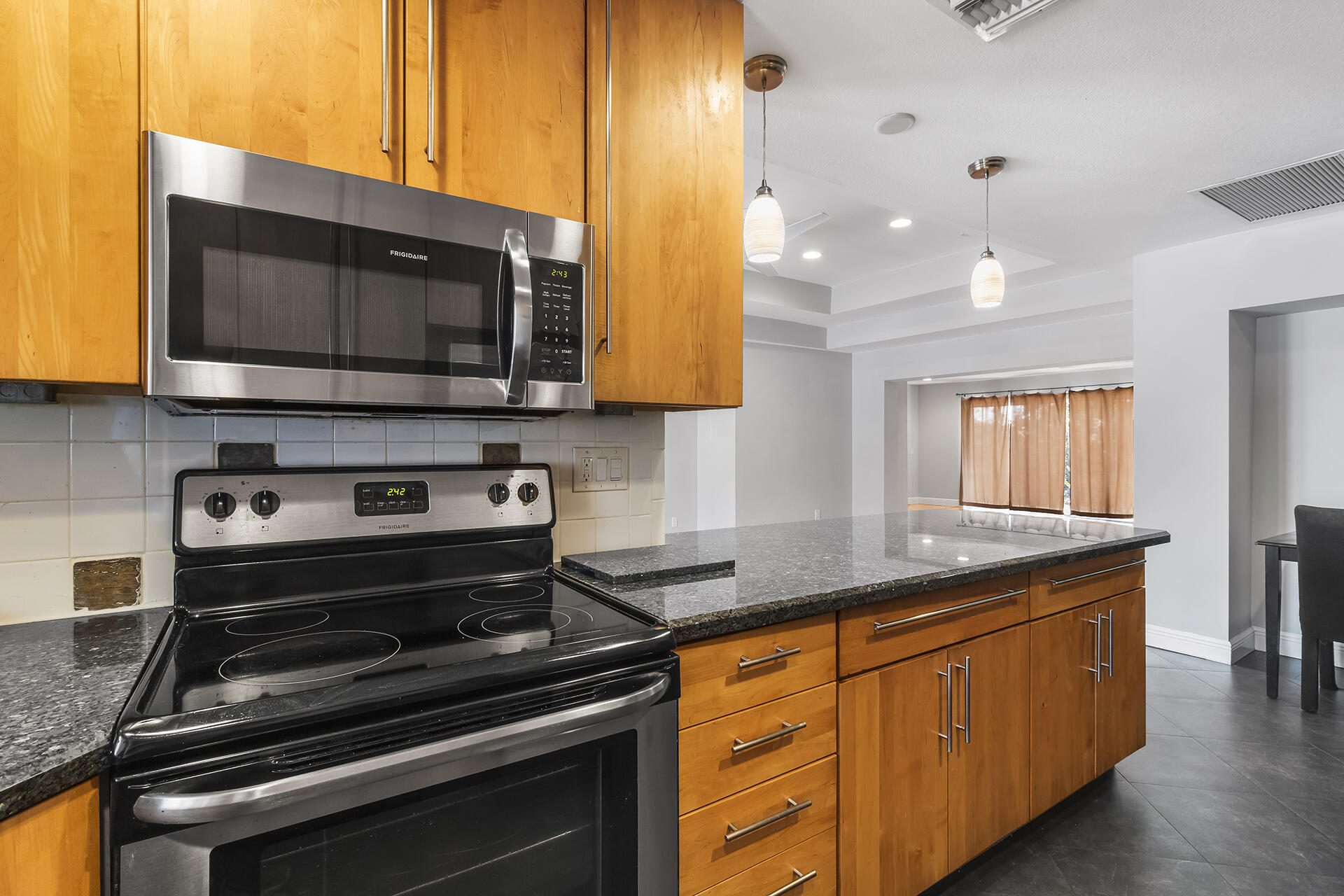 298 Northwest 11th Street Boca Raton, FL 33432 - Photo 12 of 21 a kitchen with stainless steel appliances a stove a microwave sink and cabinets