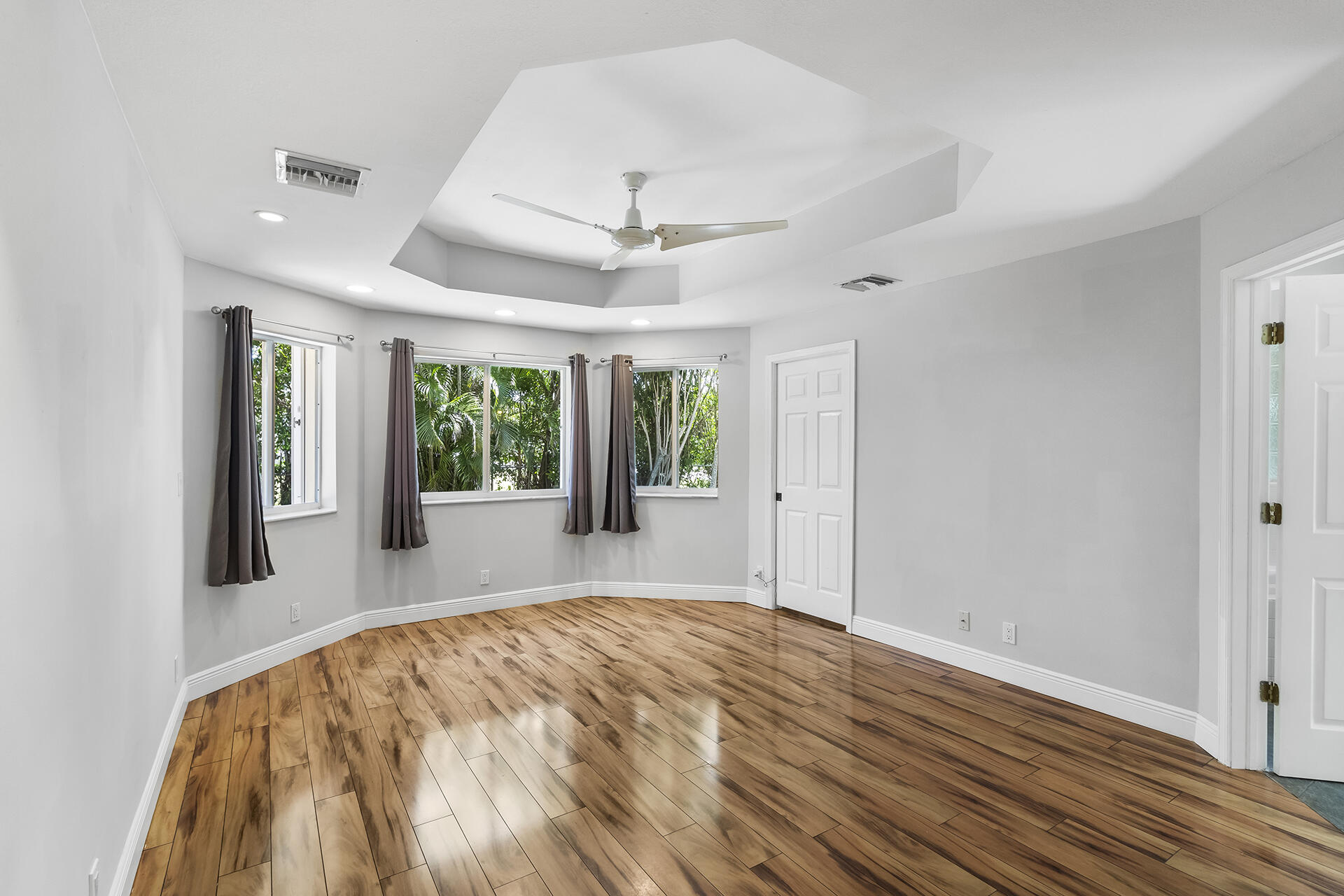 298 Northwest 11th Street Boca Raton, FL 33432 - Photo 14 of 21 a big room with wooden floor a ceiling fan and windows
