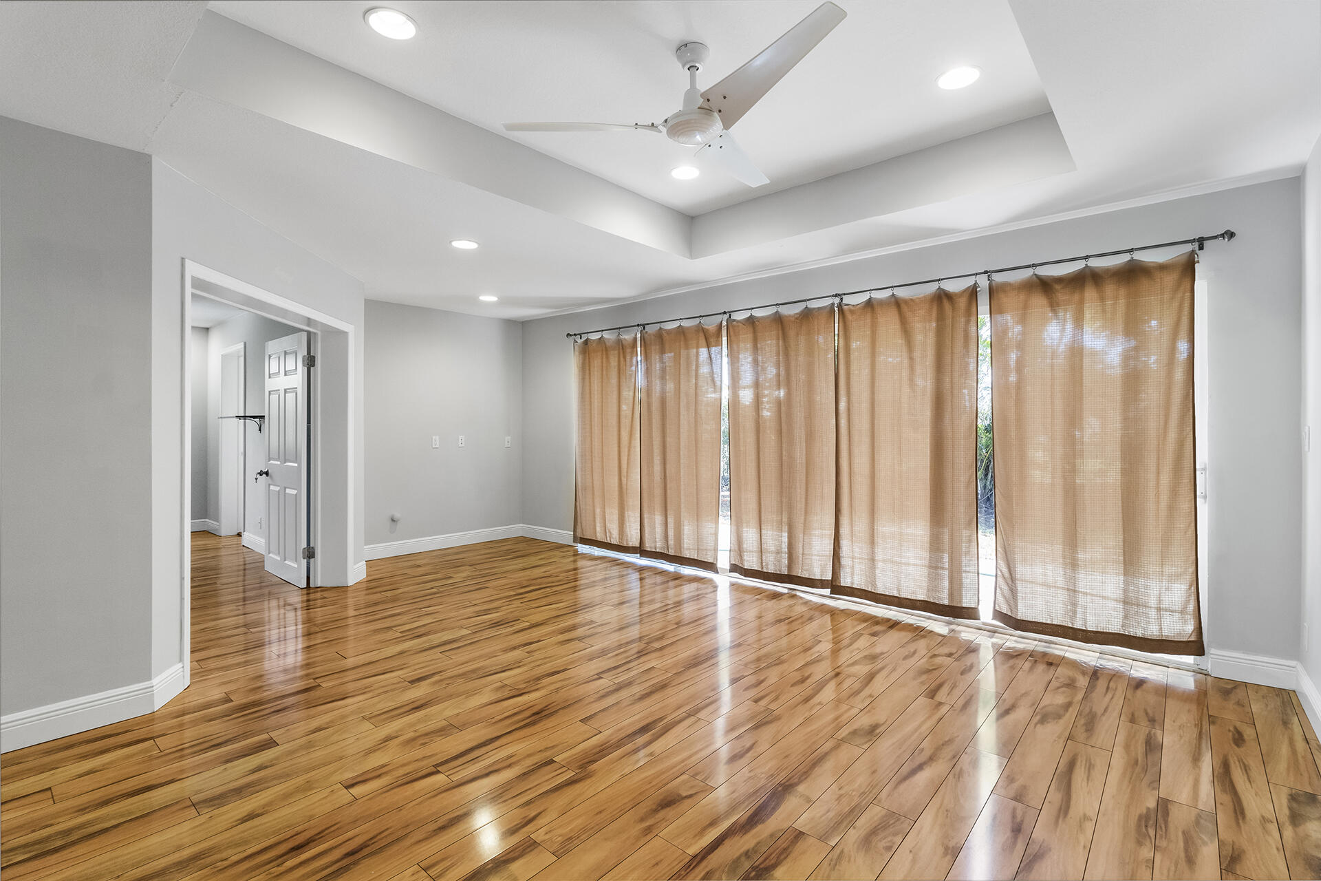 298 Northwest 11th Street Boca Raton, FL 33432 - Photo 8 of 21 an empty room with wooden floor and windows