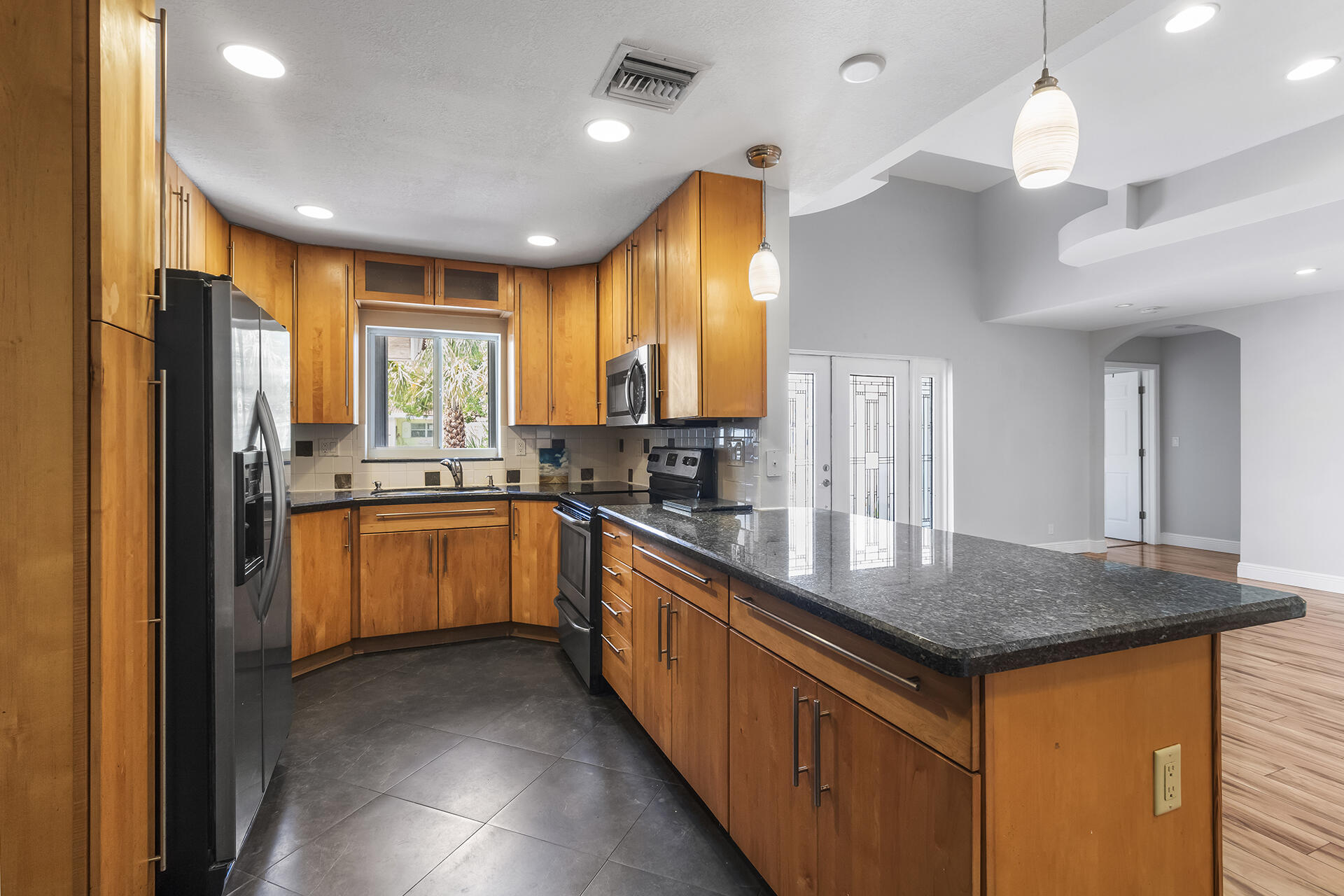 298 Northwest 11th Street Boca Raton, FL 33432 - Photo 10 of 21 a kitchen with stainless steel appliances granite countertop a sink a stove and refrigerator