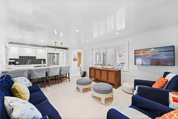 a living room with furniture kitchen view and a table