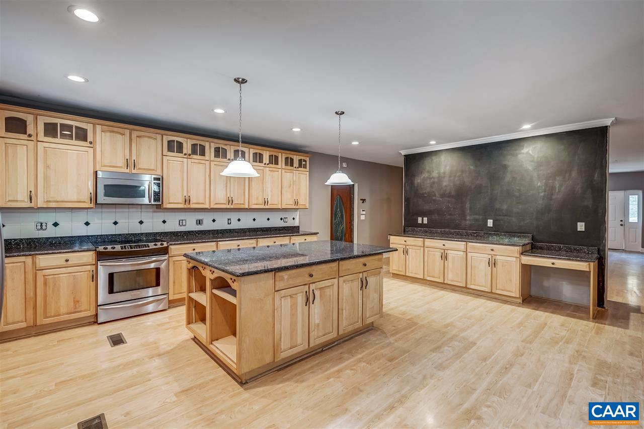 5595 New Line Road Gum Spring, VA 23065 - Photo 14 of 36 a large kitchen with stainless steel appliances granite countertop a stove and a sink