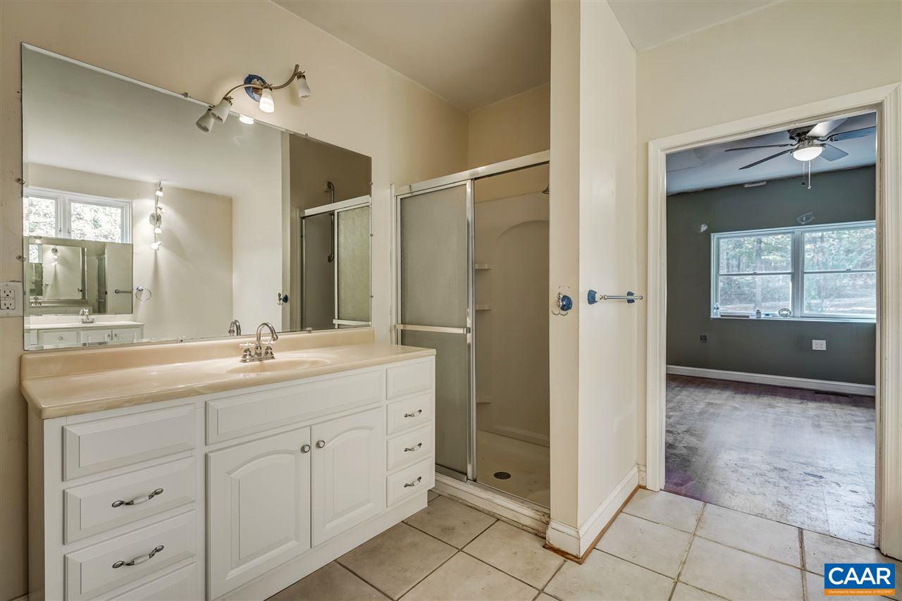 5595 New Line Road Gum Spring, VA 23065 - Photo 32 of 36 a bathroom with a shower sink and mirror