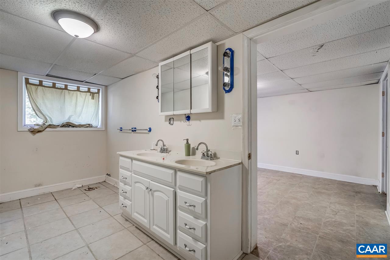 5595 New Line Road Gum Spring, VA 23065 - Photo 35 of 36 a spacious bathroom with a double vanity sink and a mirror