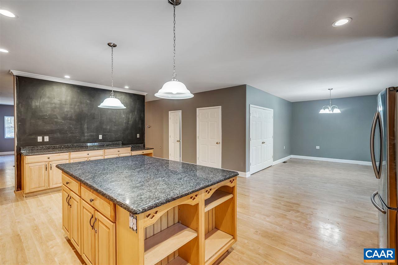 5595 New Line Road Gum Spring, VA 23065 - Photo 7 of 36 a view of a kitchen island a chandelier and wooden floor