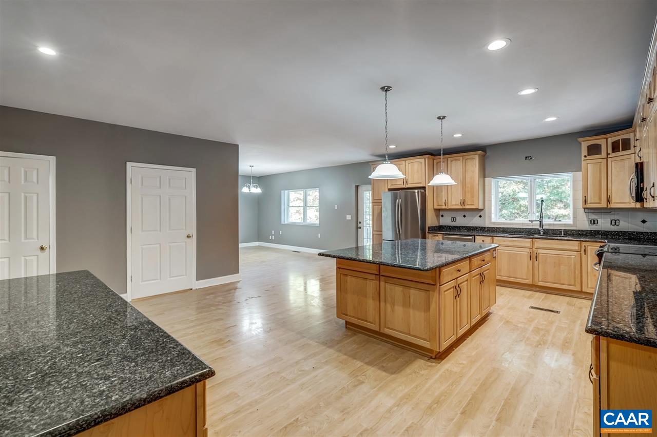 5595 New Line Road Gum Spring, VA 23065 - Photo 8 of 36 a kitchen with stainless steel appliances granite countertop a stove a sink and a refrigerator