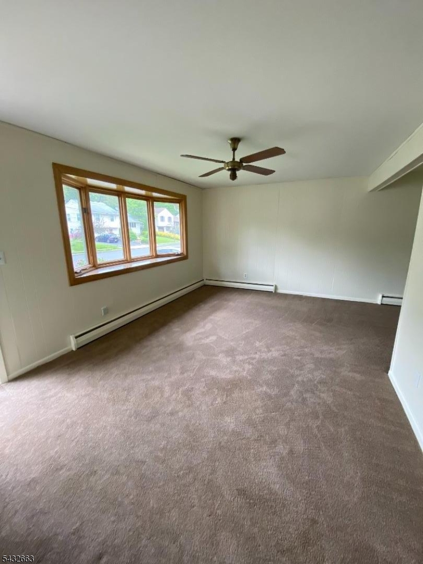 721 Lawrence Road Bound Brook, NJ 08805 - Photo 2 of 21 an empty room with windows and fan