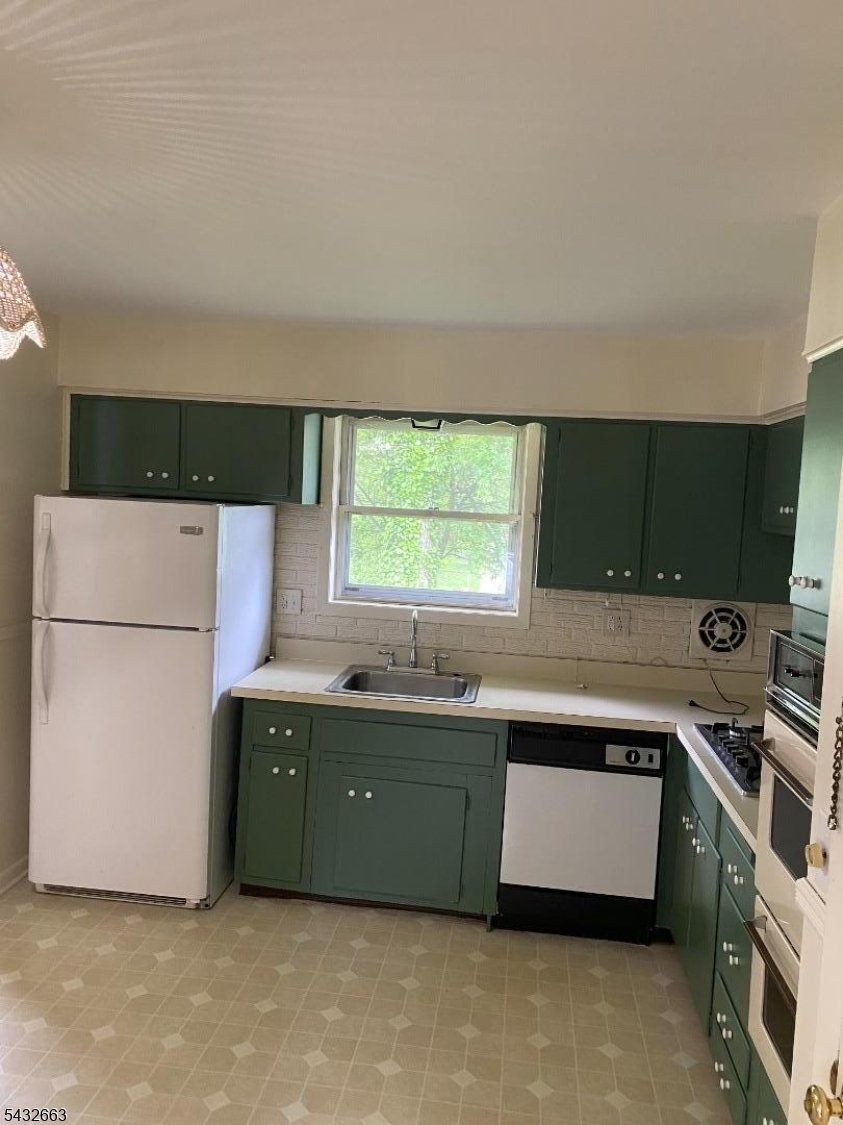 721 Lawrence Road Bound Brook, NJ 08805 - Photo 7 of 21 a kitchen with a cabinets and white stainless steel appliances