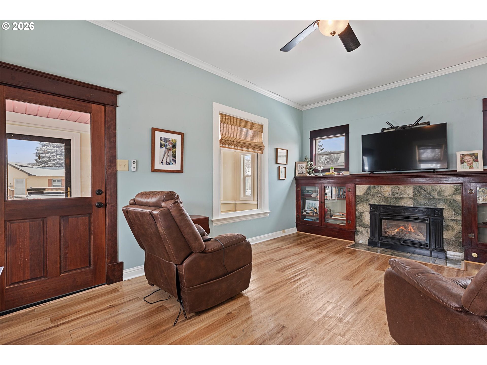 1439 3rd Street Baker City, OR 97814 - Photo 12 of 42 a living room with furniture a flat screen tv and a fireplace